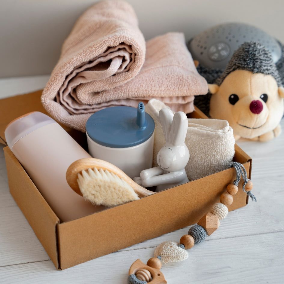 newborn essentials gift box set with baby care products and towel